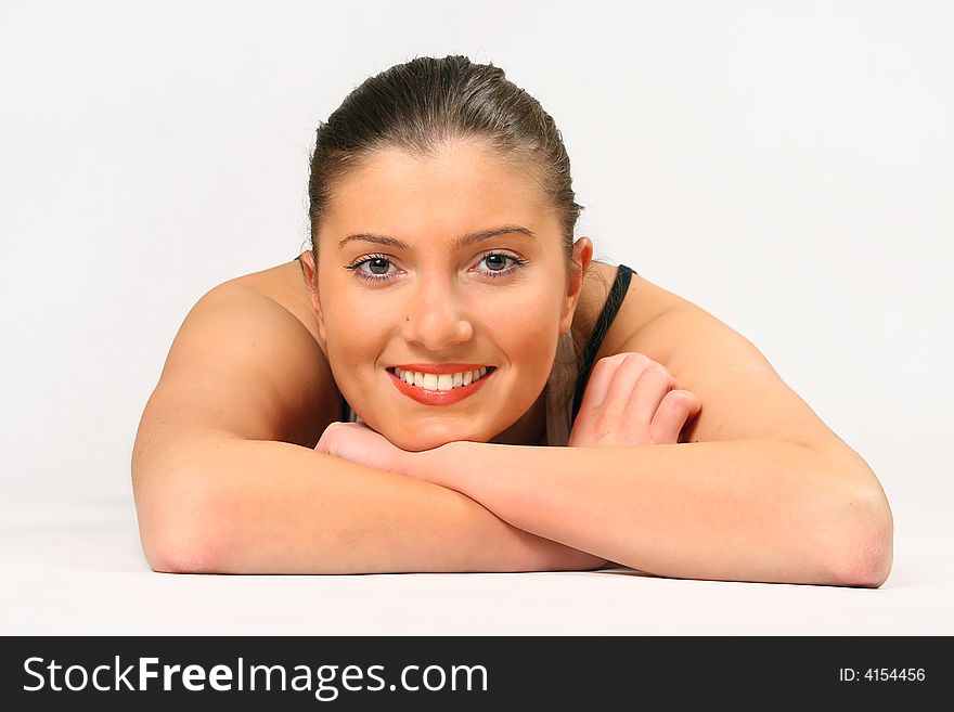 Young woman is lying over white background