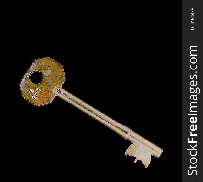 Old brass key isolated on black
