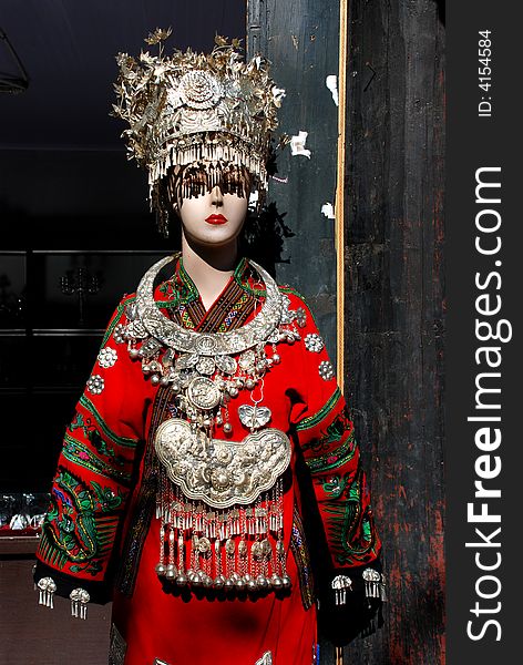 a plastic model covered, hanged with chinese silver accouterments of the local Naxi ethnic people,Shuhe Town,Lijiang,Yunnan,China,Asia