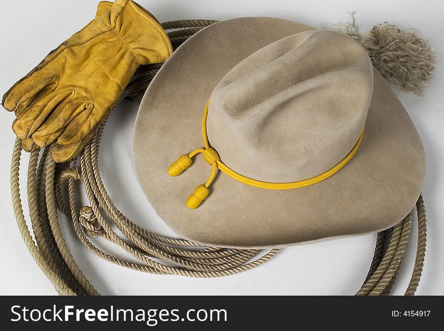Cowboy hat on top of rope with gloves. Cowboy hat on top of rope with gloves