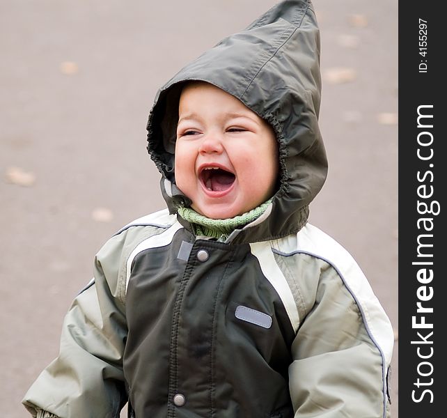 Shouting baby in green hood