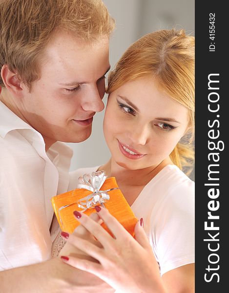 Young happy attractive couple with gift