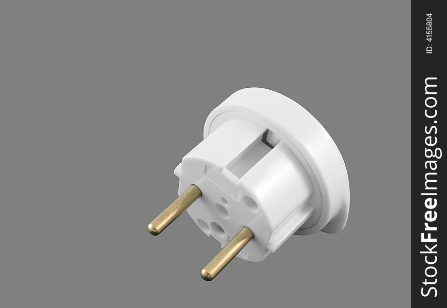 Travel adaptor to convert British electrical plug to European isolated on grey background