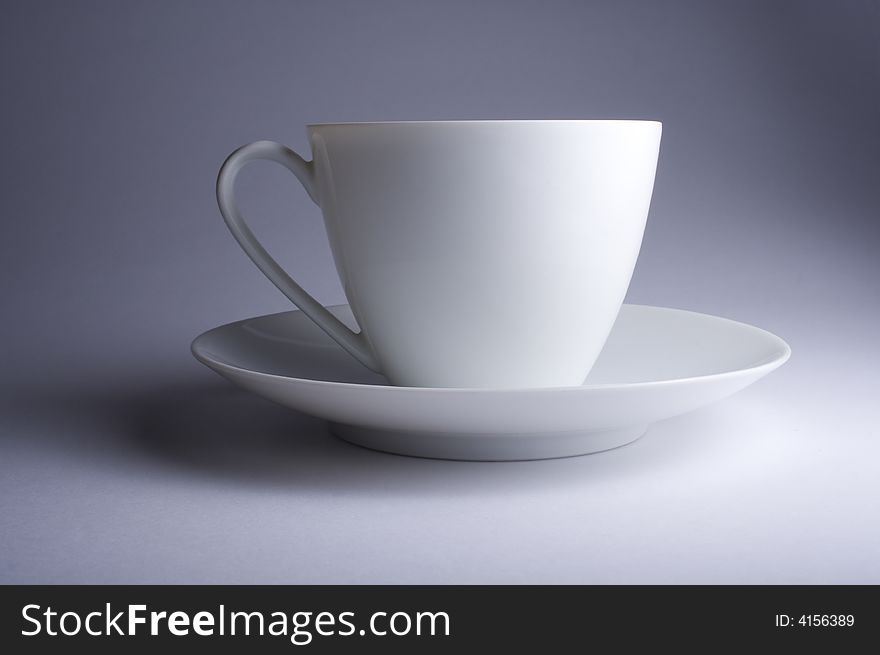 Cup and saucer against a plain background with nice gradient