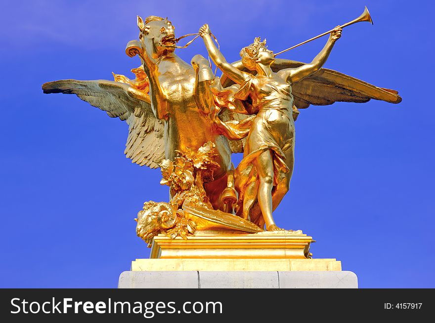 France, paris: Statues of Alexander III bridge; blue sky and a gold wing horse with his amazone