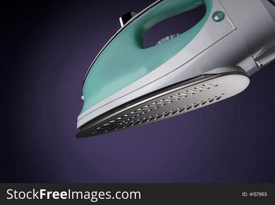Electric iron on violet  background