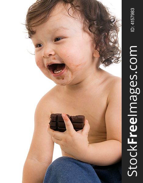 Child eats chocolate, isolated on a white background. Child eats chocolate, isolated on a white background.