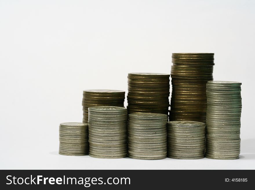 Close-up of multicolor coins stacks on the white background (isolated on white)