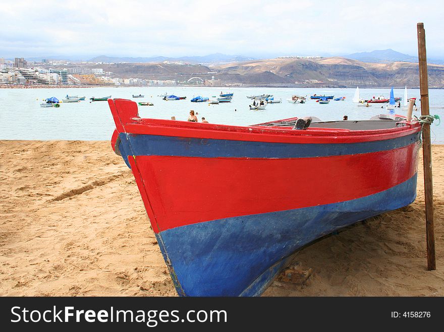 Blue and red fishing boat at the seashore. Blue and red fishing boat at the seashore