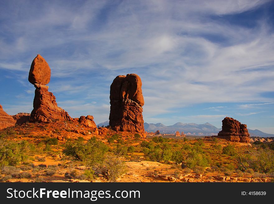 View of the red rock formations in Arches National Park with blue skyï¿½s and clouds