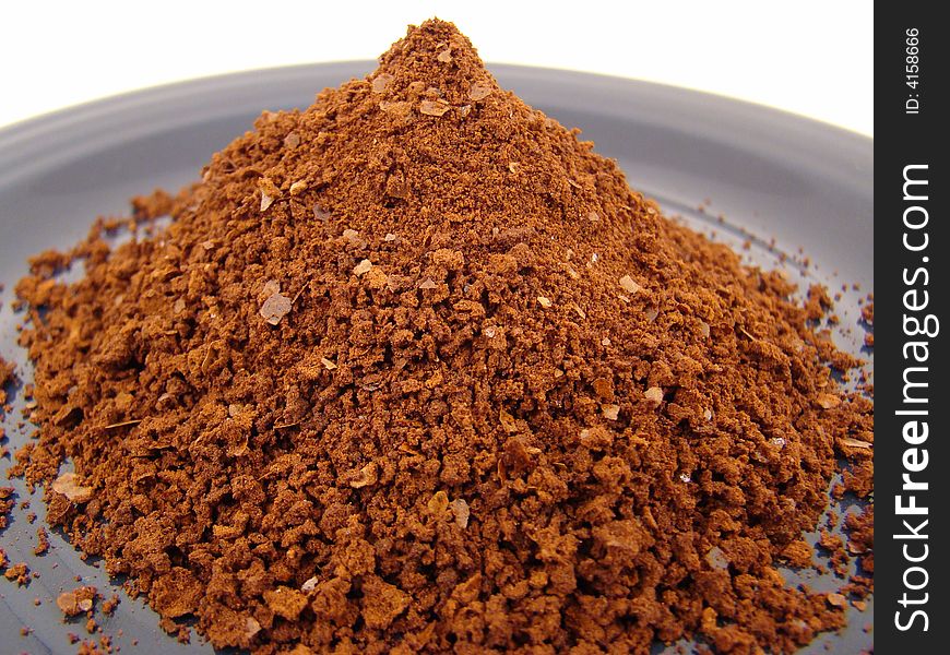 A Pile of Instant Coffee on a Blue Plate.