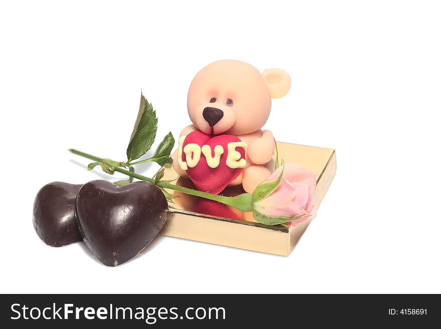 Valentines day background - rose and two chocolate hearts and sugar bear. Valentines day background - rose and two chocolate hearts and sugar bear