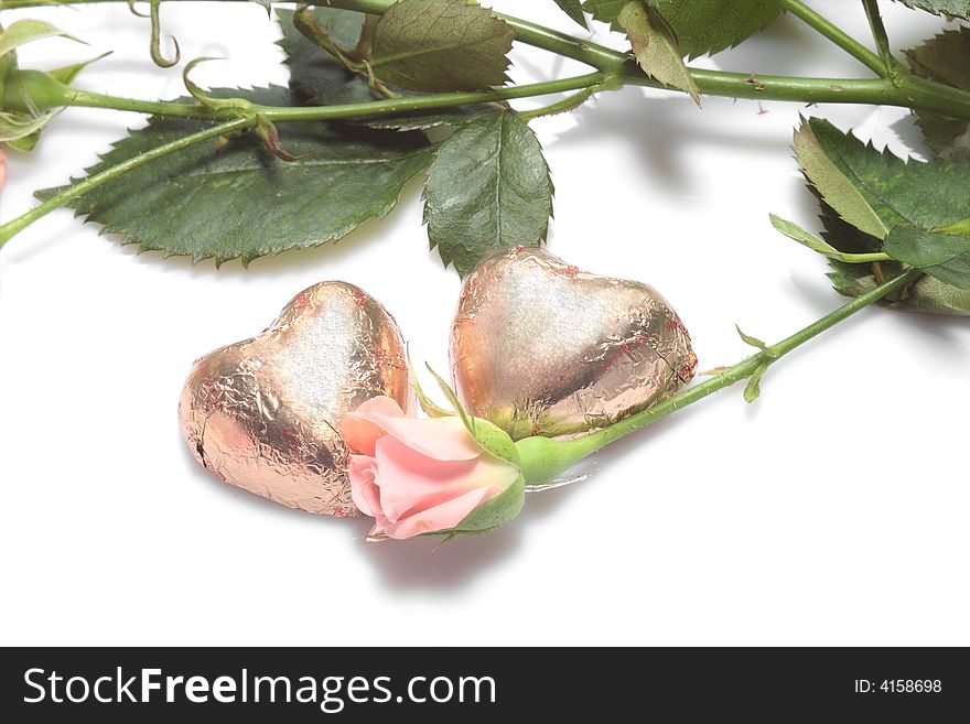 Valentines day background - rose and two chocolate hearts. Valentines day background - rose and two chocolate hearts