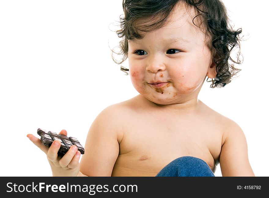 Child eats chocolate, isolated on a white background. Child eats chocolate, isolated on a white background.