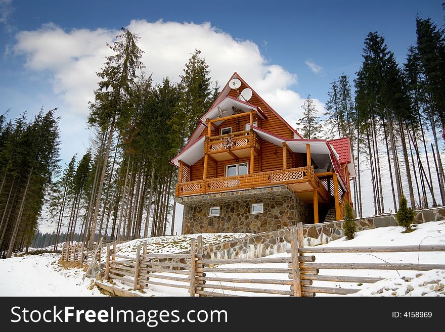 Wooden house in the winter in Carpathians