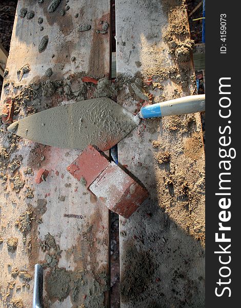 Trowel cement and brick at construction site. Trowel cement and brick at construction site