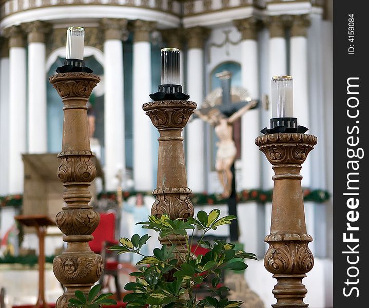 Three large wooden candle holder in a church. Three large wooden candle holder in a church