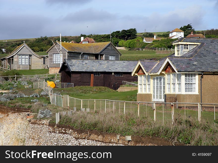 A small village on the coast of England before storm with some sun beams left in the front. A small village on the coast of England before storm with some sun beams left in the front.