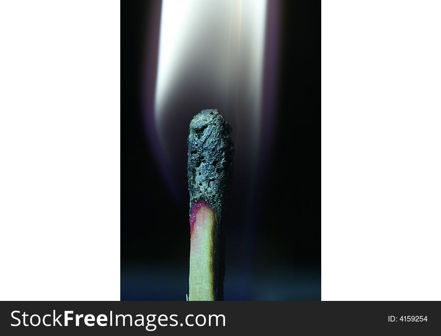 The image burning matches, very largly, on a black background white fire