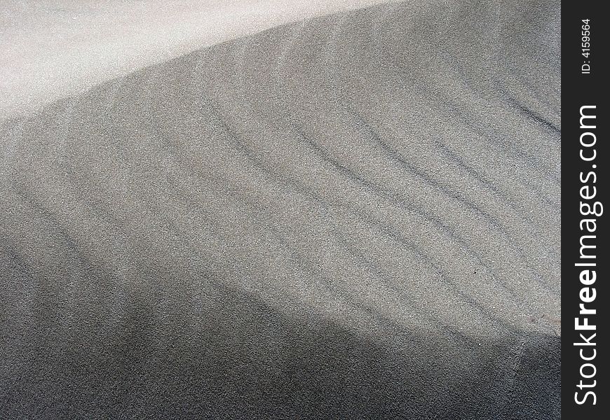 Close-up picture of fine sand with different tones and curves. Nice texture. Close-up picture of fine sand with different tones and curves. Nice texture.