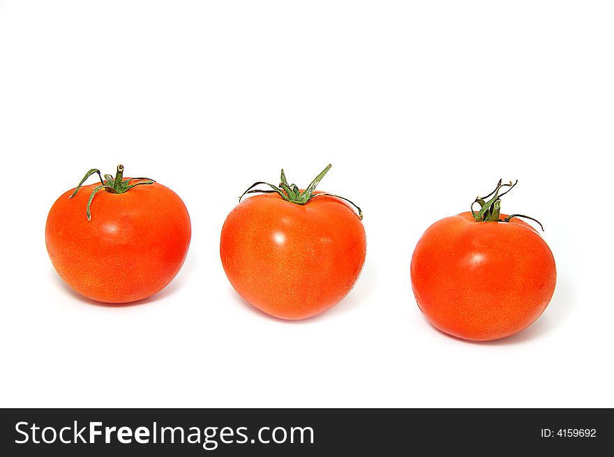 Three ripe red tomatos with green ends isolated on white. Three ripe red tomatos with green ends isolated on white
