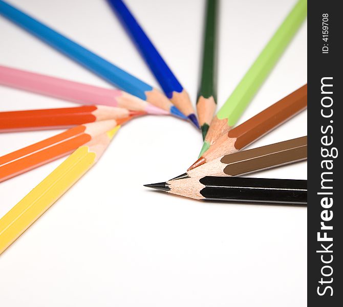 Colorful pencils isolated un white background, focus on black one. Colorful pencils isolated un white background, focus on black one