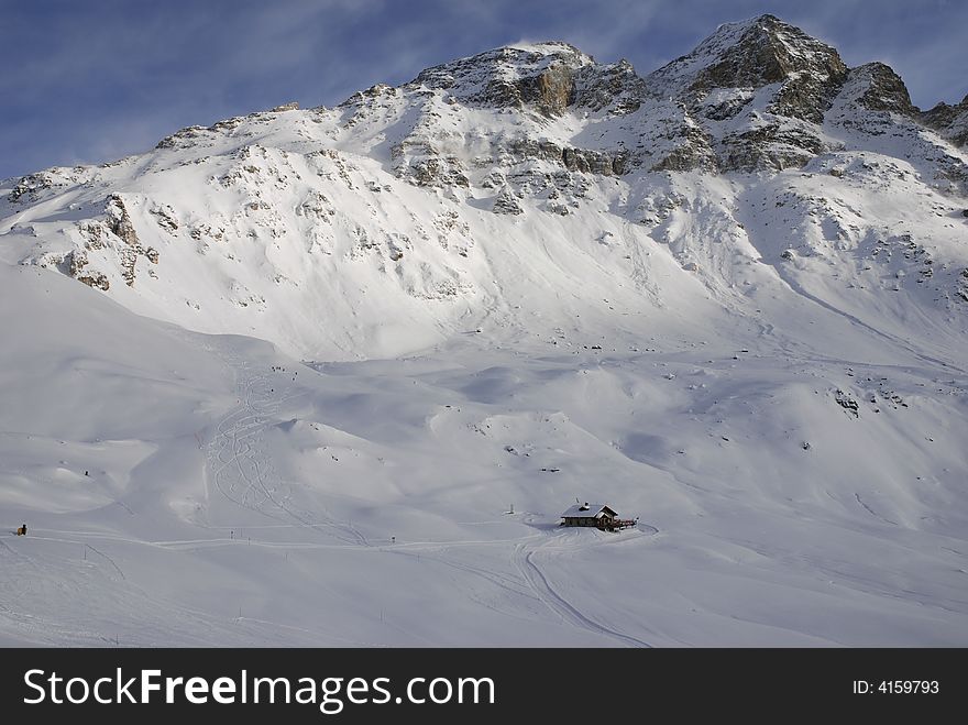 Alps house on a background  on a mountain. Alps house on a background  on a mountain