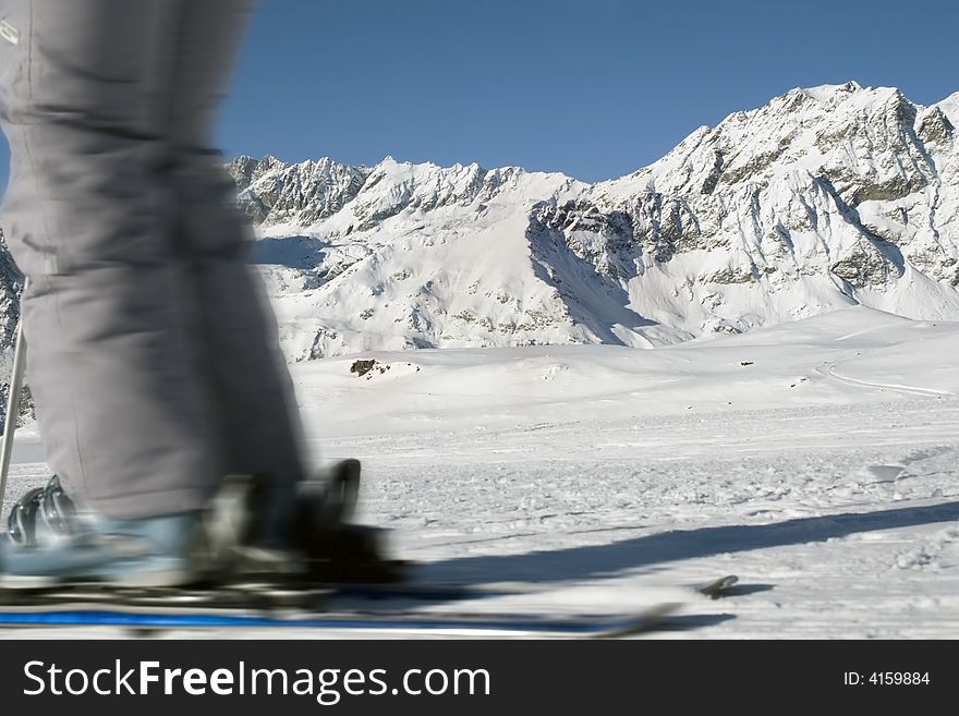Quick skier on a background of mountains