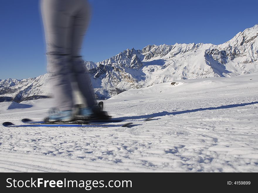Quick skier on a background of mountains
