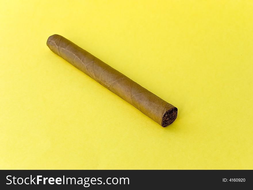 A cigar on the yellow background.