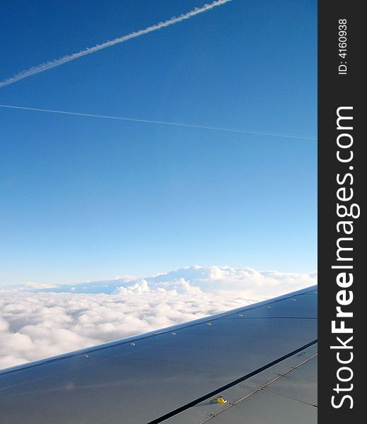 Clouds section and plane from flying aircraft. above the clouds.