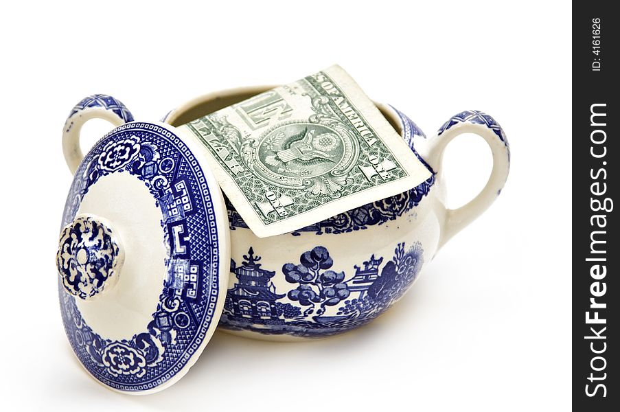 An American dollar in a sugar bowl.  Concept about economy and savings. An American dollar in a sugar bowl.  Concept about economy and savings.