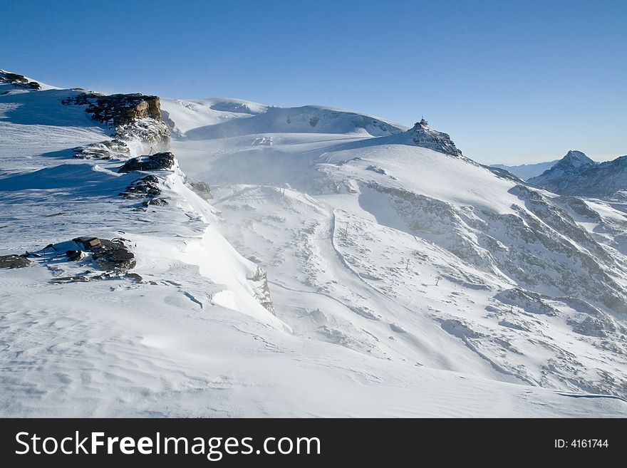 View from Klein Matterhorn glacier. Altitude about 3800m. Swiss Alps. Ski resourt close to Zermatt/Matterhorn. View from Klein Matterhorn glacier. Altitude about 3800m. Swiss Alps. Ski resourt close to Zermatt/Matterhorn.