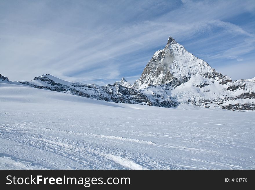 Matterhorn peak - landmark of Swiss Alps. Sky with fleecy clouds. Switzerland. Matterhorn peak - landmark of Swiss Alps. Sky with fleecy clouds. Switzerland