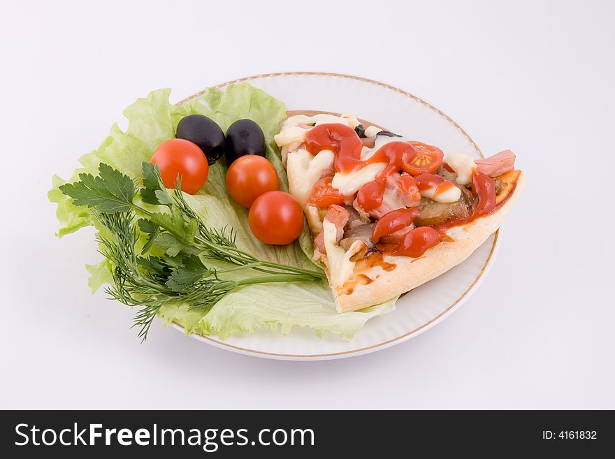 Piece of a pizza with vegetables on a plate on a white background