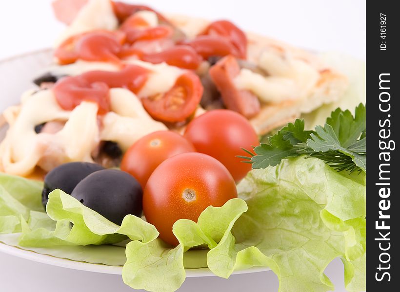 Piece of a pizza with vegetables on a plate on a white background (close up). Piece of a pizza with vegetables on a plate on a white background (close up)