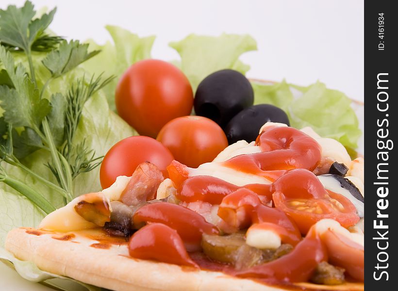 Piece of a pizza with vegetables on a plate on a white background (close up). Piece of a pizza with vegetables on a plate on a white background (close up)
