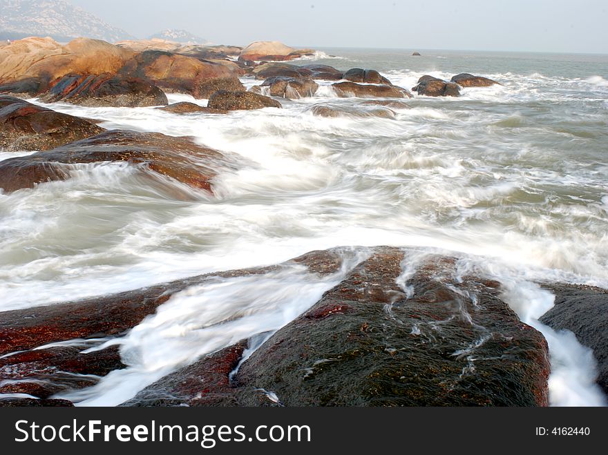 Waves rush the boulders by the seaside of taishan,guangdong,china. Waves rush the boulders by the seaside of taishan,guangdong,china