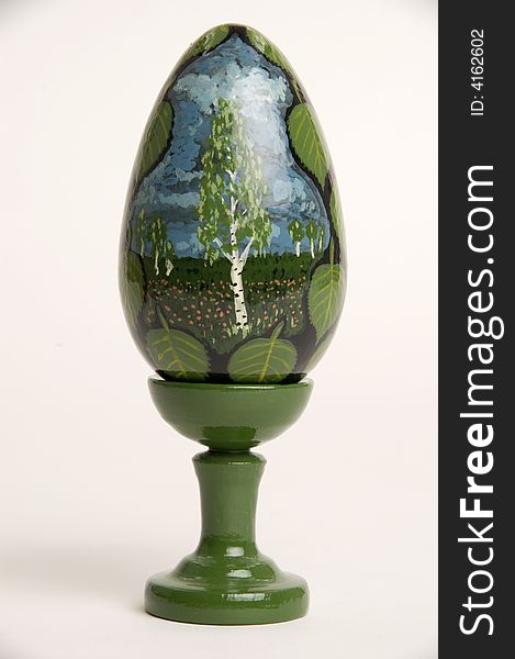Green easter egg with figure on a support. Green easter egg with figure on a support.