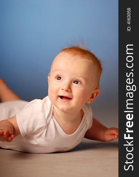 A smiling little boy on a floor