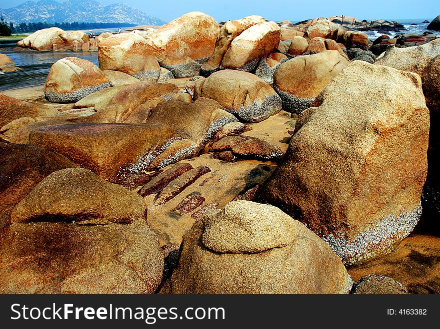 Brown and yellow boulders by the south china seaside. Brown and yellow boulders by the south china seaside