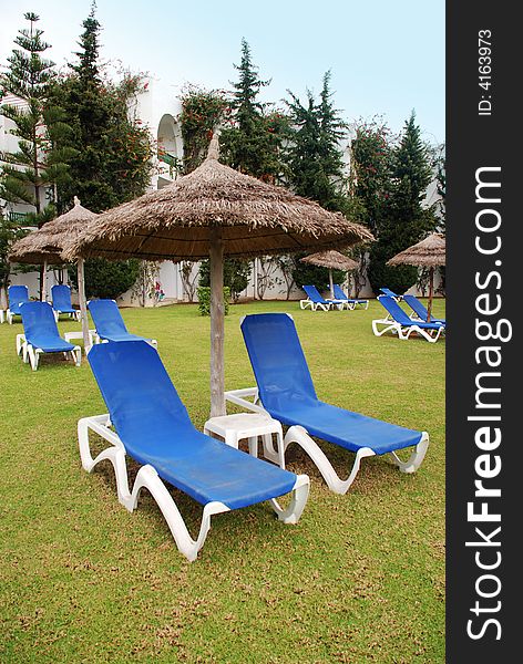 Lots of blue deckchairs beside a hotel in Tunisia.