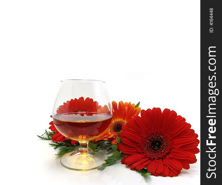 Congratulatory card with cognac and red flowers on a white background