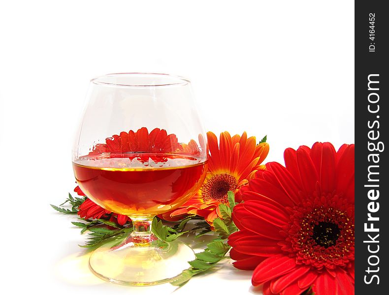 Congratulatory card with cognac and red flowers on a white background