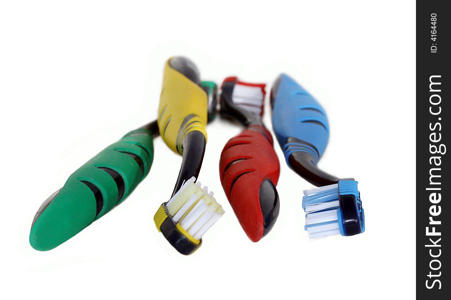 A family tooth-brushes in four colors isolated