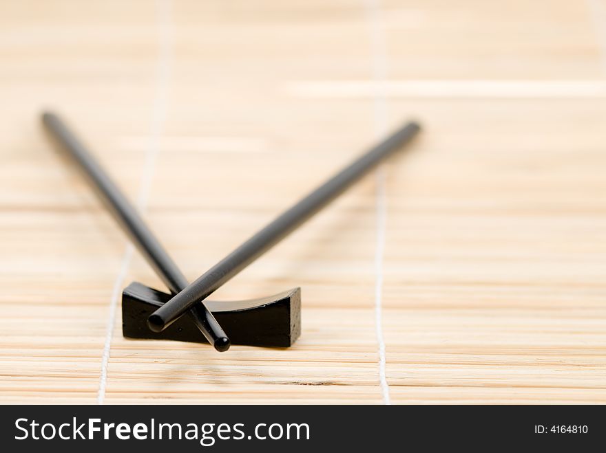 Japanese chop sticks on bamboo mat