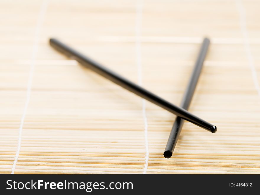 Japanese chop sticks on bamboo mat