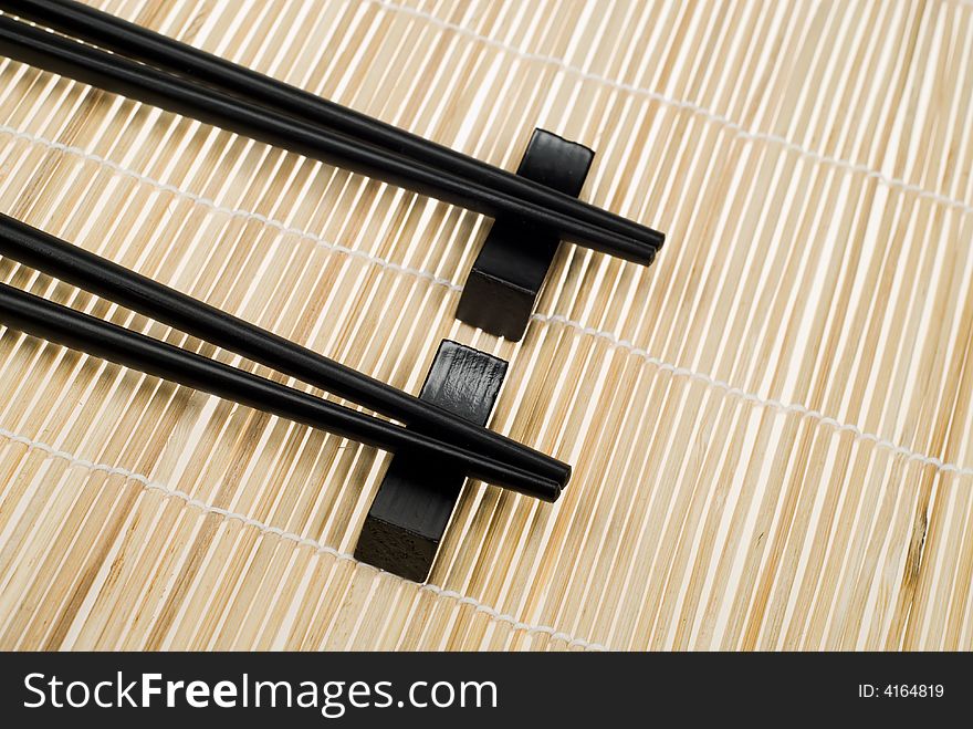 Japanese chop sticks on bamboo mat