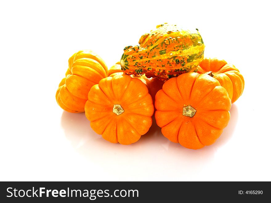 Orange pumpkins with a textured orange gourd on top. Orange pumpkins with a textured orange gourd on top.