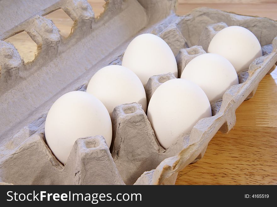 White eggs in cardboard carton